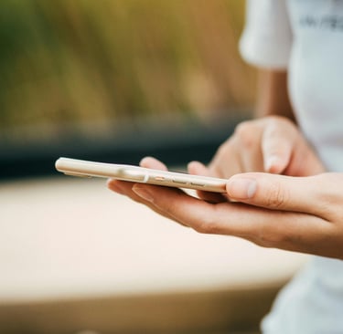 a person holding a cell phone in their hands