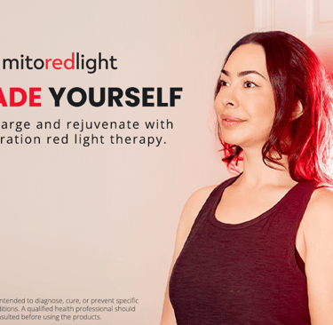 a woman with red hair and a black tank top