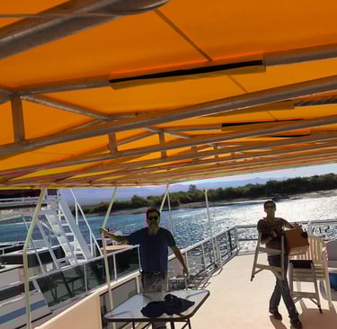 Replacing Houseboat Party Top cover made with Sunbrella Marine Fabric.