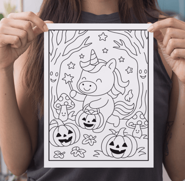a woman holding up a coloring page for halloween