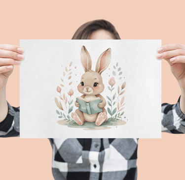 Woman holding a poster in front of her face featuring a watercolor bunny reading a book with floral 