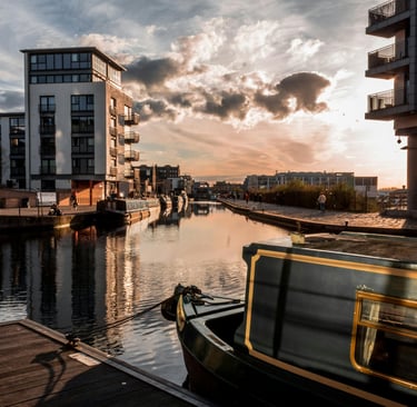 a boat on a river with buildings in the background