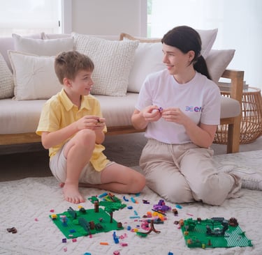 Image of a young boy and OT Frances playing with Lego