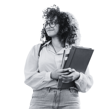 A woman holding books and folders looking away from the camera smiling