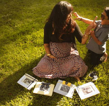 a woman mom and a boy sitting on the grass family photography san diego california
