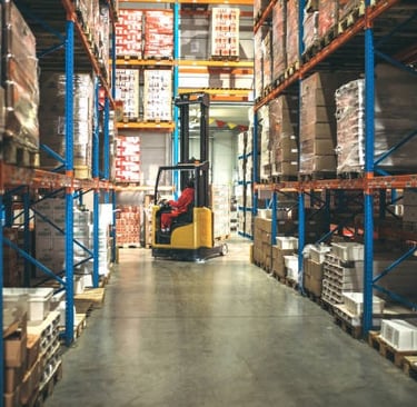 Forklift operator inspecting racking