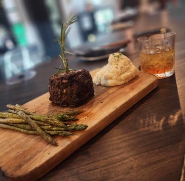 a steak filet dinner asparagus, mashed potato, smoked old fashion