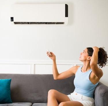 a woman sitting on a couch with a remote control