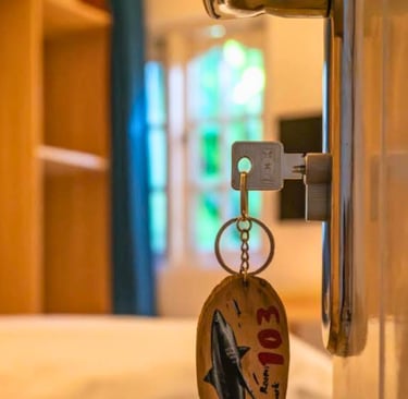 Bright guest room at Scuba Haven Guesthouse in Fuvahmulah, Maldives, with open door and key inside