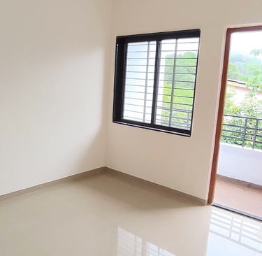 Cozy bedroom at Lakefield Apartments with natural light and hill view at Igatpuri