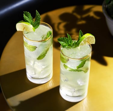 two glasses of water with lemonade and mint leaves