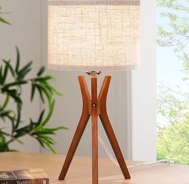 a mid-century tripod lamp that is sitting on a table
