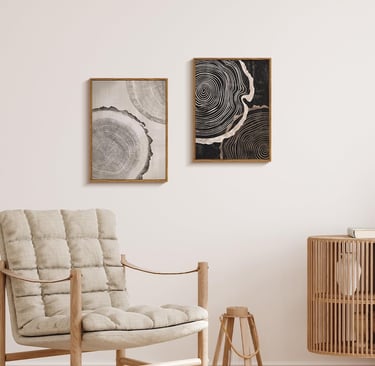 a chair with a hanging neutral wall art and a wooden cabinet