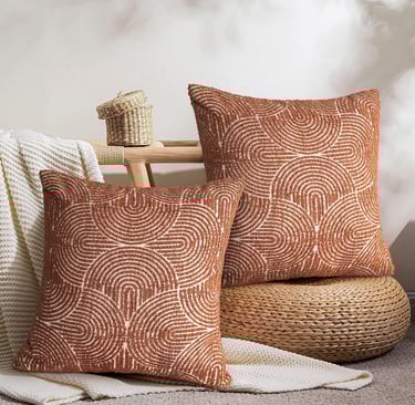 a pair of decorative pillows with a brown and white swirly pattern