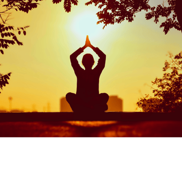 woman seated in lotus position in flow with hands aloft in reverence