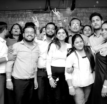 a group of people standing around a man in a white shirt