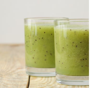 two glasses of kiwis with kiwis on them