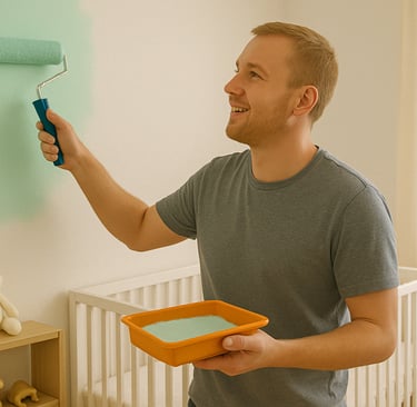 homme qui peint une chambre de bébé avec un rouleau et de la peinture dans les mains