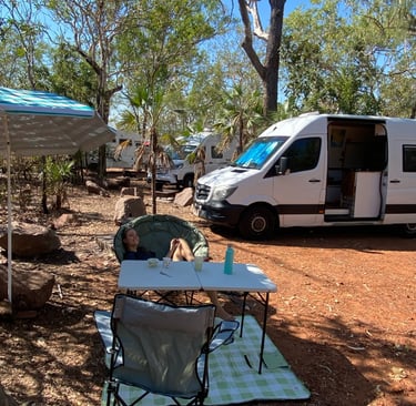 white campervan with table and chairs outside