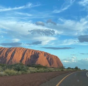a road with a road sign and a road sign