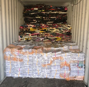 over issued newspaper  and used bicycles loaded in a container for export to Afghanistan