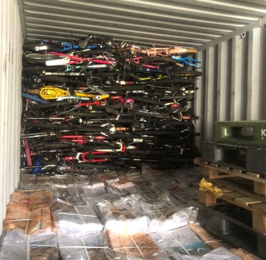 old newspapers, used bicycles and other goods loaded in a container for export to Afghanistan