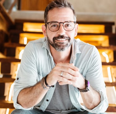 professional photo of Michael Franco, HR and employee engagement leader, smiling on a stair case.  