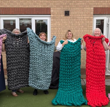 a group of people holding up blankets and blankets