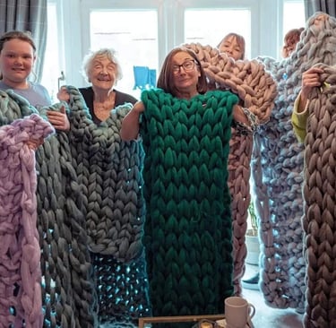 a group of people holding up blankets and blankets