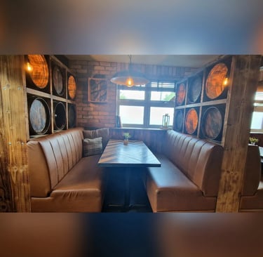 a couch with a table and chairs in a restaurant