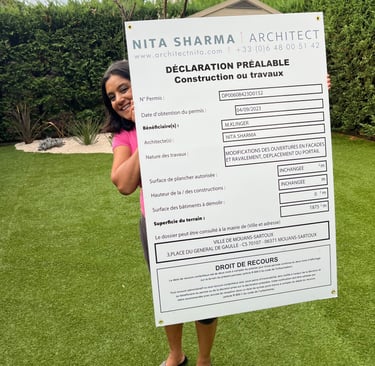 English Architect Nita Sharma holding a permission board