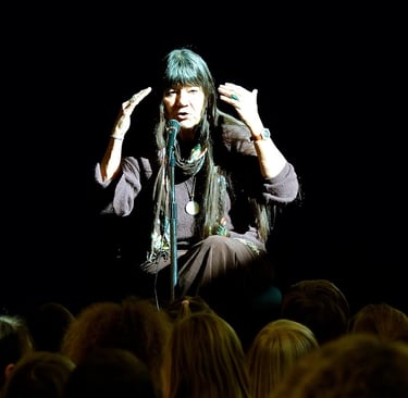 storyteller Dovie Thomason performs on stage