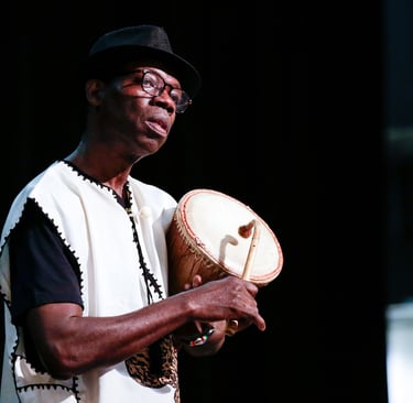 artist Kofi Dennis drums during a performance (credit: Zaw Lin)