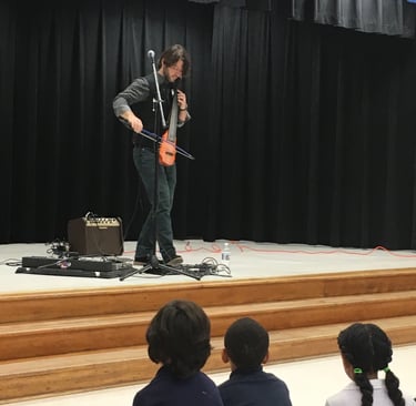 cellist Wytold performs at a school