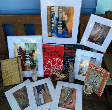 a bunch of greeting cards and framed pictures of guitars and books