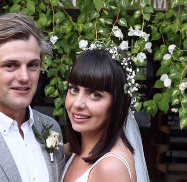 a bride with a floral head piece and groom posing at their wedding is Bali