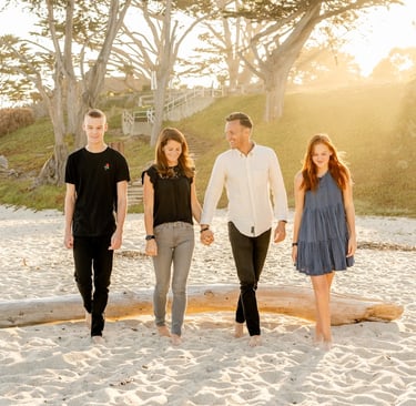 An Empty Nest Family walking on a beach.