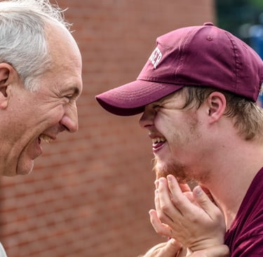 Happy Dad and Son Smiling at Each Other