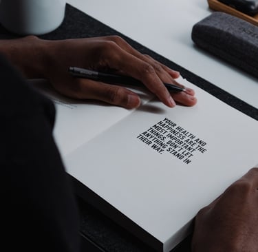 Hand, holding a pen on a page ready to write