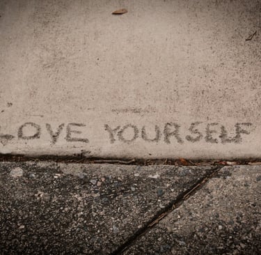 The Words Love Yourself engraved into the pavement