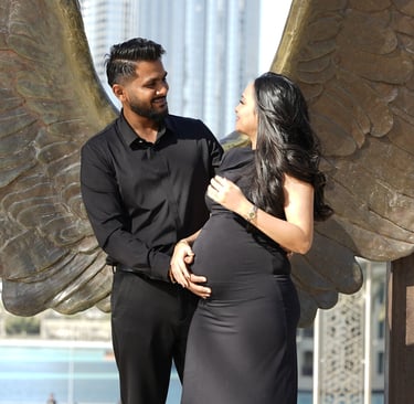 Black-and-white maternity portrait – Expecting mother holding belly at Wings of Mexico Dubai.
