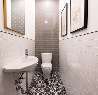 a small powder room design with a toilet and a sink