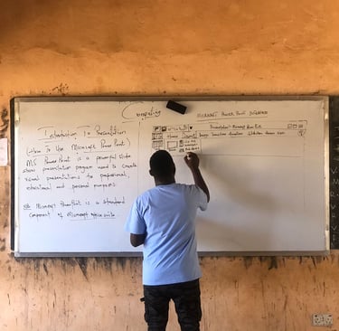 teacher in Ghana teaching computer science on a whiteboard