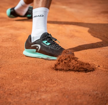 a tennis player's foot in the middle of a tennis court