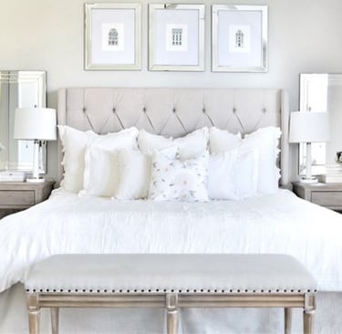 a bedroom with a bed and a bench with a bench and a bench with a