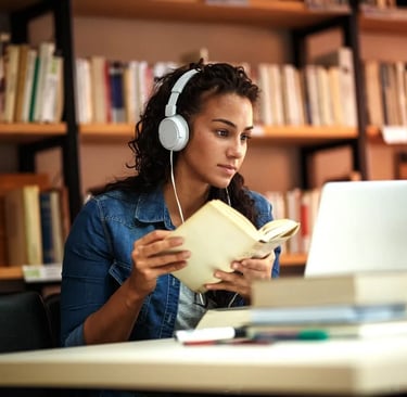 a woman in headphones and headphones is sitting at a desk