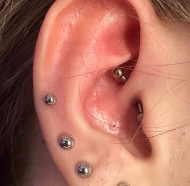 Close-up of a daith piercing with titanium barbell at Piercing by Jooles Montrose
