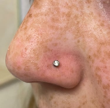 Safe nose piercing with titanium hoop in Montrose