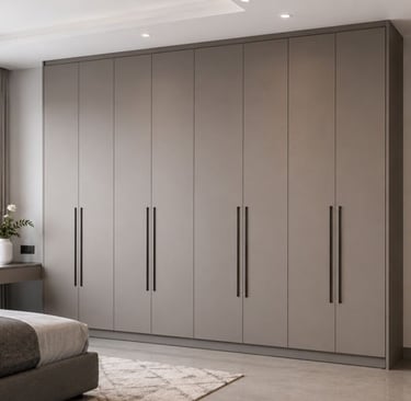 Modern floor-to-ceiling built-in wardrobe in a beige minimalist bedroom design.