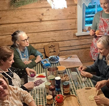 a group of people sitting around a table with food